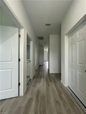 a view of hallway with wooden floor
