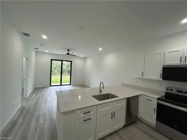 a kitchen with sink cabinets and window
