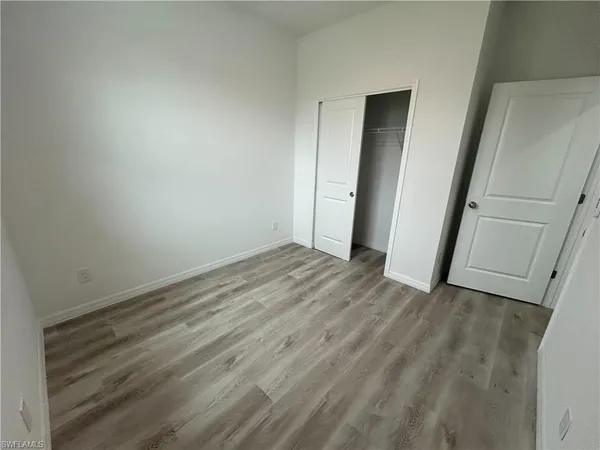 an empty room with wooden floor
