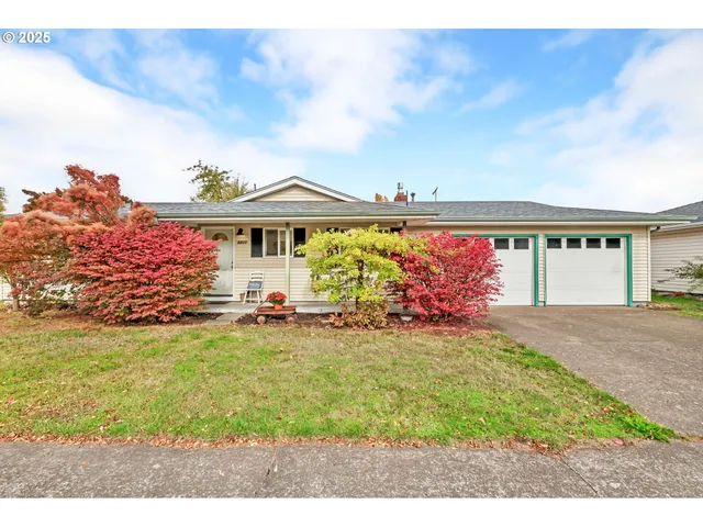 a view of a house with a yard and potted plants