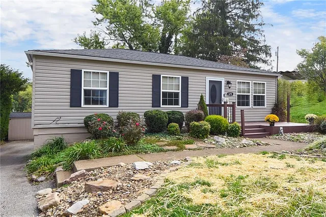 a view of a house with backyard and sitting area