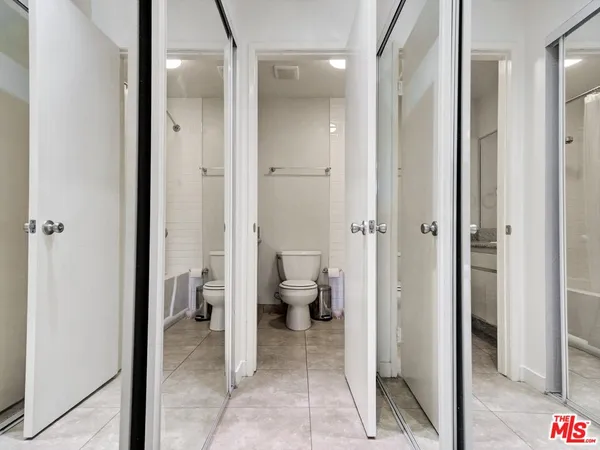 a bathroom with a granite countertop toilet sink and shower