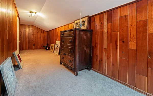 a view of an empty room with wooden walls