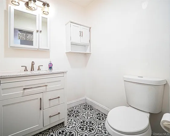 a bathroom with a toilet a sink and mirror