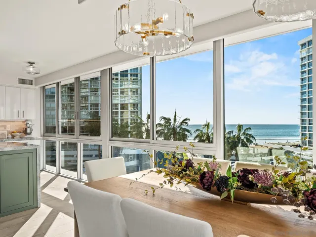 a view of a dining room with furniture a chandelier and wooden floor
