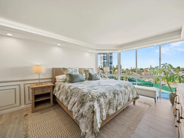 a spacious bedroom with a bed and a dresser