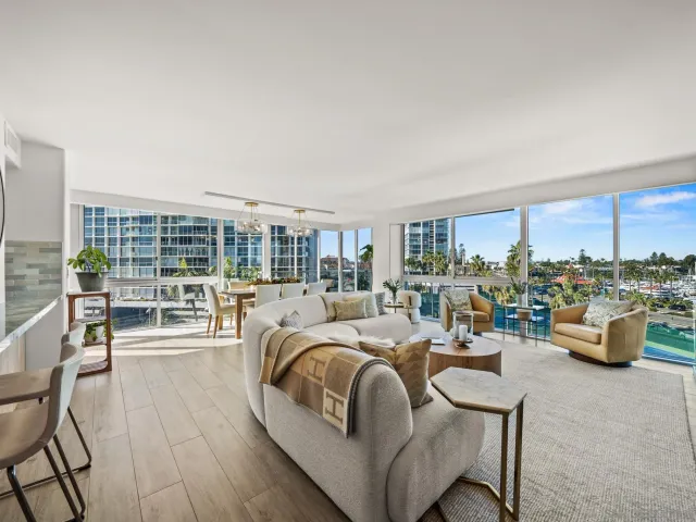 a living room with couch a fireplace and a floor to ceiling window