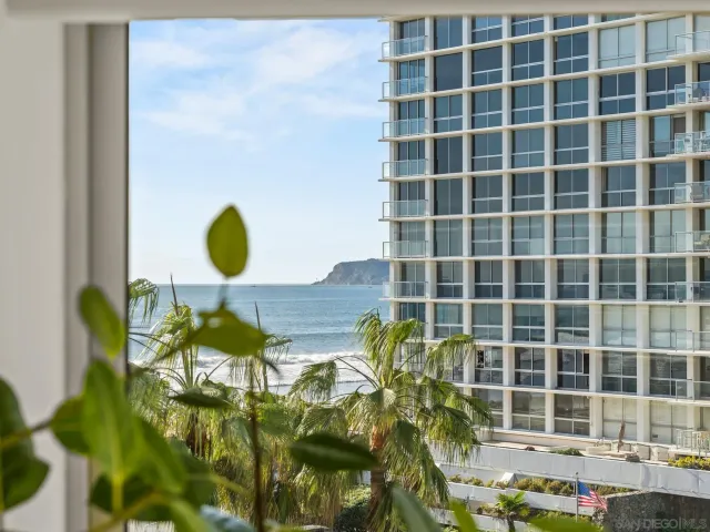 a view of a dining room with furniture wooden floor and a potted plant