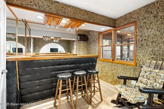 a kitchen with stainless steel appliances granite countertop a refrigerator a stove top oven a sink dishwasher and white cabinets with wooden floor