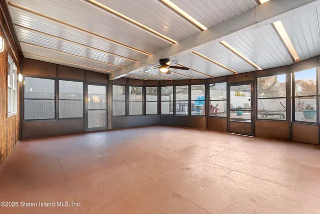 a spacious bedroom with a bed and ceiling fan