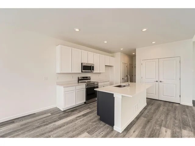 a open kitchen with cabinets stove and sink