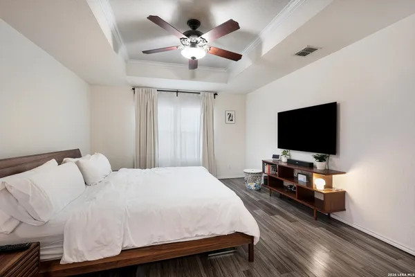 a bedroom with a bed and a flat screen tv