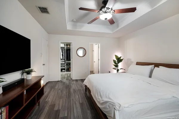 a bedroom with a bed and a flat screen tv