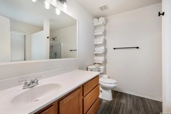 a bathroom with a sink toilet and shower