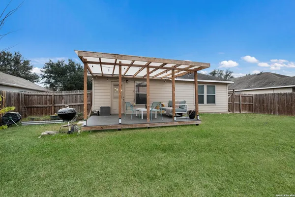 a view of a house with backyard porch and sitting area