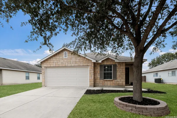 a front view of a house with a yard garage and fountain