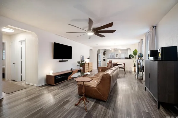 a living room with furniture wooden floor and a flat screen tv
