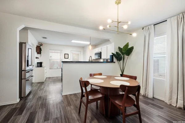 a view of a dining room with furniture and wooden floor