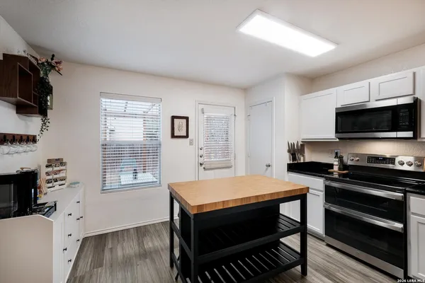a kitchen with a stove a sink and a microwave