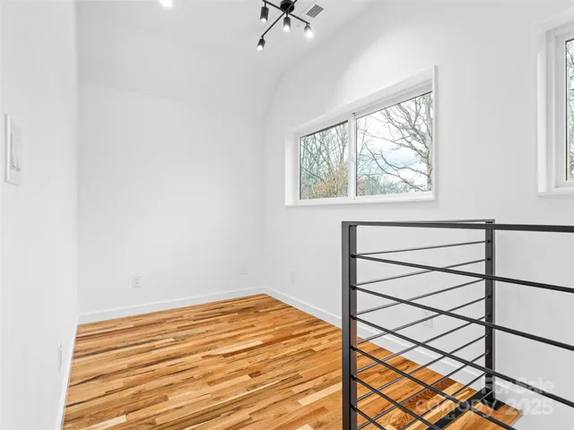 a view of a room with a window and a ceiling fan