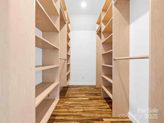 a view of walk in closet with empty racks