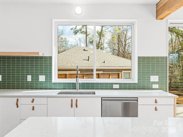 a kitchen with a sink and large window