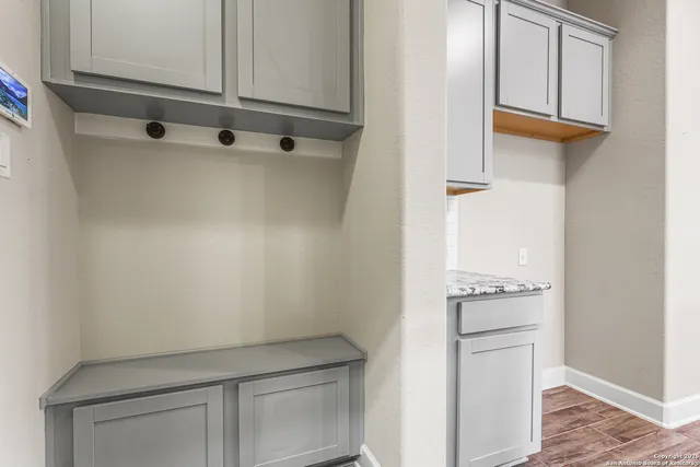 a kitchen with white cabinets and white appliances