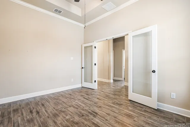a view of an empty room with wooden floor