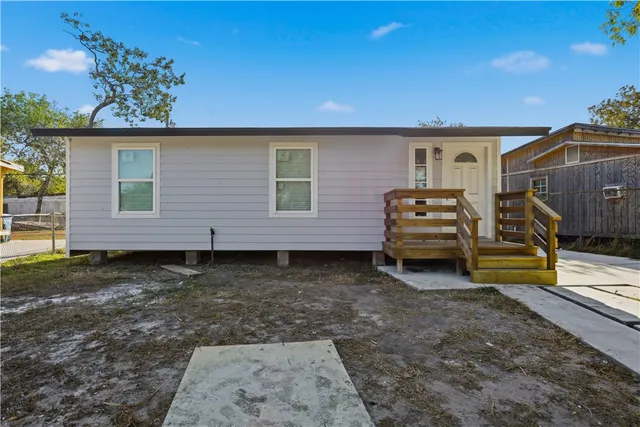 a view of a backyard with a car parked in patio