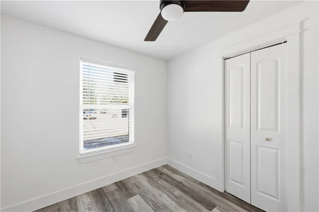 a view of an empty room with closet and window