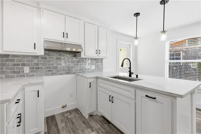 a kitchen with sink cabinets and window