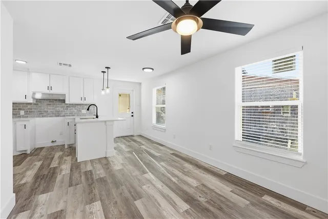 a large kitchen with a large window cabinets and stainless steel appliances