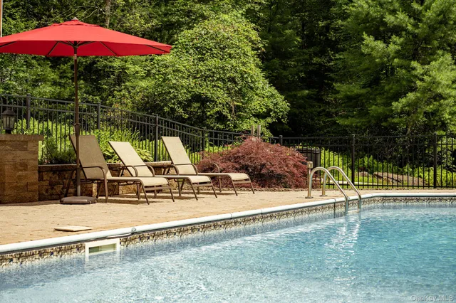 a view of a patio with a table and chairs under an umbrella