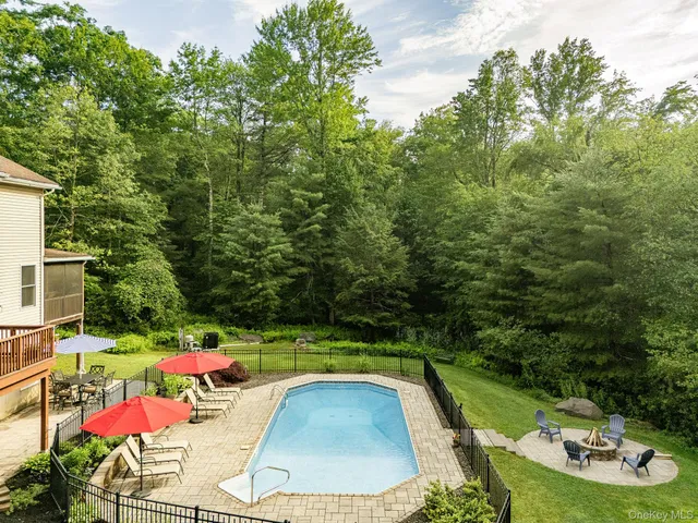 an outdoor space with swimming pool and furniture