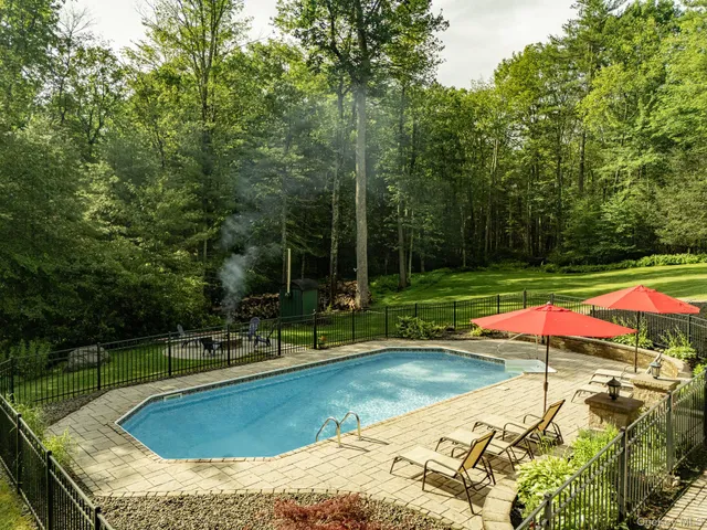 a view of a swimming pool with lounge chairs