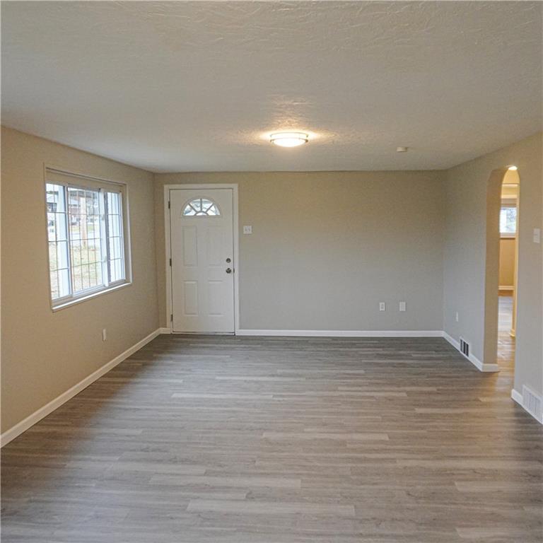 216 Roberts Road Pittsburgh, PA 15239 - Photo 8 of 17 a view of an empty room with wooden floor and a window