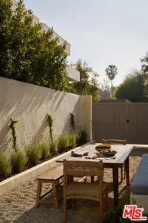 a view of a dinning table and chairs on the roof deck
