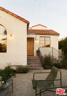 a view of a house with backyard and sitting area