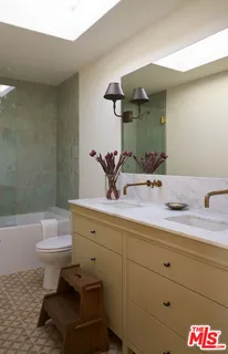 a bathroom with a sink a toilet and bathtub