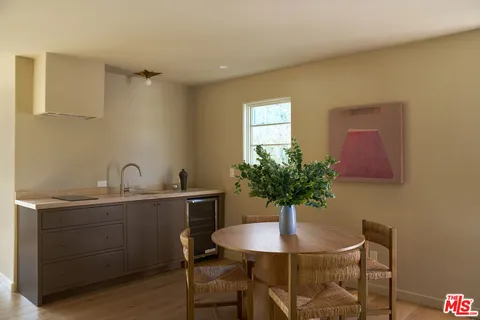 a view of a kitchen with a table and chair in it