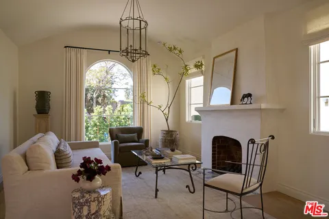 a living room with furniture fireplace and window