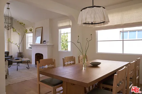 a view of a dining room with furniture and a chandelier