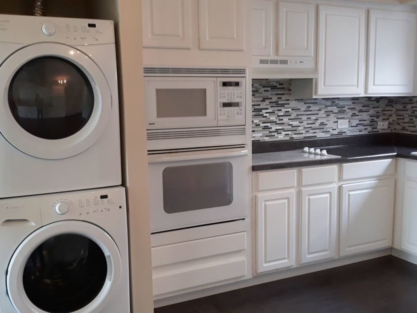 955 North Rohlwing Road, Unit 101A Addison, IL 60101 - Photo 3 of 13 a kitchen with white cabinets and sink