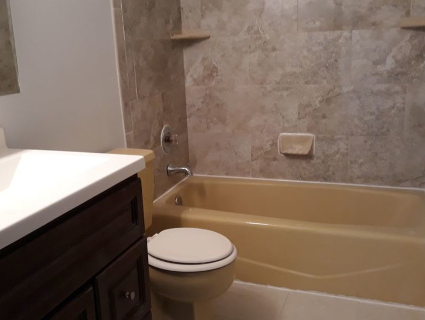 955 North Rohlwing Road, Unit 101A Addison, IL 60101 - Photo 6 of 13 a bathroom with a sink a toilet and shower