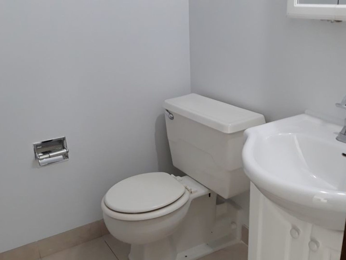 955 North Rohlwing Road, Unit 101A Addison, IL 60101 - Photo 7 of 13 a white toilet sitting next to a white sink