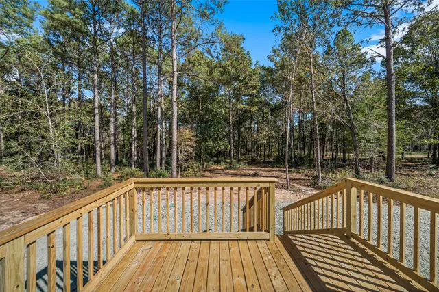 a view of balcony with wooden floor and fence