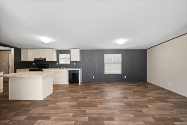 a view of a kitchen with microwave and cabinets