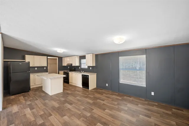 a kitchen with a refrigerator and a sink