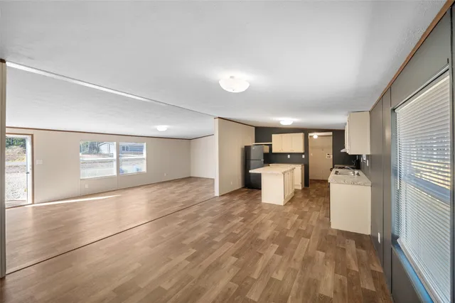 a living room with furniture and kitchen view
