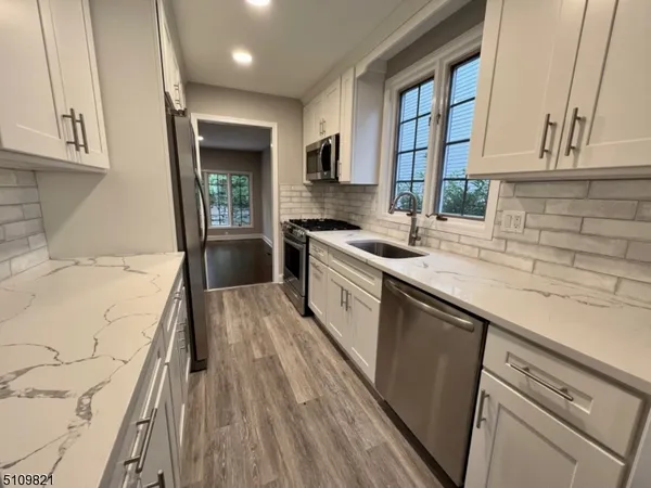 a kitchen with a sink a stove and cabinets